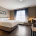 La Quinta Inn & Suites by Wyndham Montgomery guest room with king bed, desk, and large window