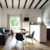 Résidence Les Cigales in Porto-Vecchio: studio-style room with sofa, dining table, chairs and kitchenette