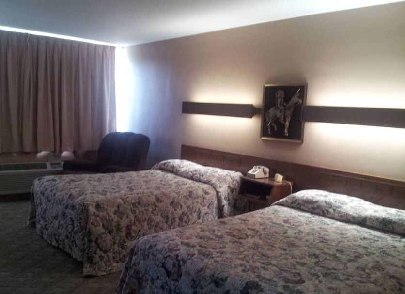 Indian Head Motel in Winamac guest room with two double beds and curtains over a window