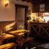 Hostal de la Laguna in Ushuaia with a cozy wood-paneled dining area and small café counter