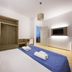 Petruso Resort in Balestrate, bedroom with double bed, blue runner, wall-mounted TV and open wardrobe