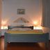 Vecchio Hotel in Rethymno bedroom with double bed, bedside lamps, and tiled floor