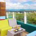 Rooftop terrace at Brizo Salta in Salta with city views, glass railing, and colorful seating