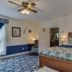 Carrier Houses Bed & Breakfast in Rutherfordton: floral canopy bed, armchair, and blue patterned carpet