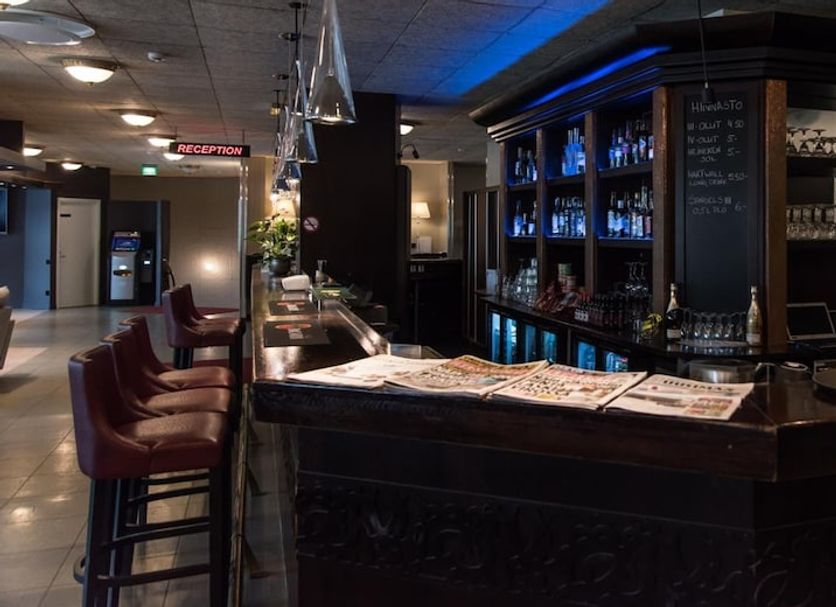 Hotelli Seurahovi in Porvoo bar area with stools, illuminated shelves, and glassware behind the counter