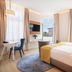 Seetelhotel Ostseehotel Ahlbeck room in Heringsdorf with twin beds, desk, round rug and balcony view
