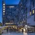 Zijin Hotel Belgrade in Belgrade, exterior courtyard with lit gazebos at dusk