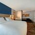 SpringHill Suites by Marriott Albuquerque University Area guest room with king bed, seating area, and TV