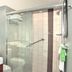 Hyatt Place Augusta bathroom with glass-enclosed shower, vanity sink, and large mirror