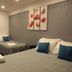 Raceway Motel Whanganui room with two beds, gray walls, and red floral wall art