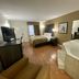 Quality Inn Branson - Hwy 76 Central room with bed, TV, desk, and jetted tub in Branson