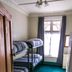 Kiwi's Nest Budget Accommodation & Backpackers in Dunedin bunk room with window and teal carpet