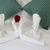 Los Milagros Hotel in Cabo San Lucas: towel swans on a bed with a red rose and green pillows