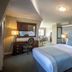 Bracken Court Hotel Balbriggan guest room with king bed, bedside lamps and sitting area