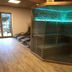 Hotel Planaiblick in Schladming spa area with glass sauna, lounge chairs and wood flooring