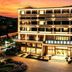 International Haiyuan Resort Hotel in Nantong at dusk, with illuminated facade and city skyline beyond
