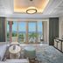 Waldorf Astoria Ras Al Khaimah suite with sea view, balcony, and sofa seating