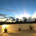 Rooftop terrace at Aht Colonial Hostel in Havana with sunset sky views and potted plants