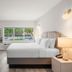 The Garden Hotel & Resort, Fort Lauderdale guest room with king bed, desk, and pool view