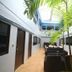 Ao Nang Beach Resort in Krabi courtyard with tall palms and seating under a skylit atrium