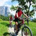 Spa Hotel Erzherzog Johann in Bad Aussee with mountain views and cyclists on a grassy trail