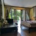 Seashell Resort Hostel Koh Tao bedroom with king bed, seating area, and balcony garden view in Ko Tao
