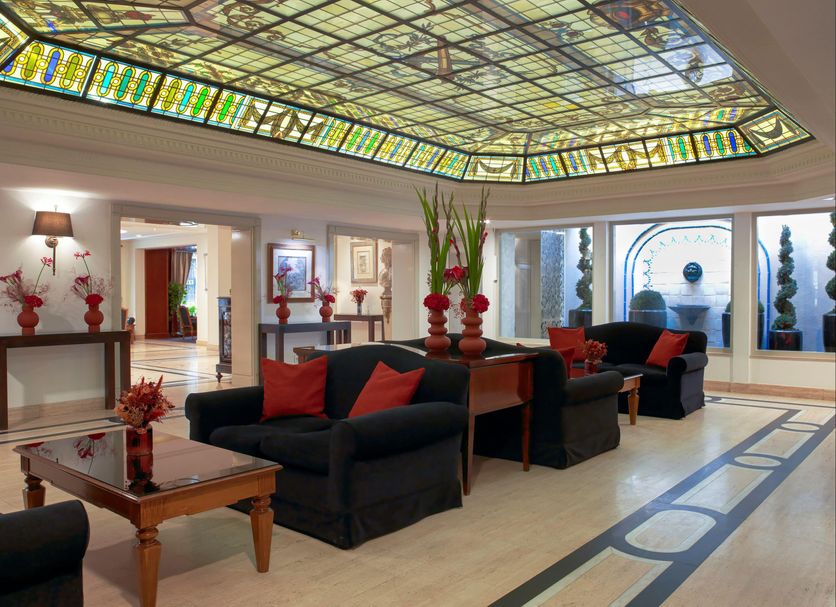 Meliá Paris Vendôme lobby in Paris with stained-glass ceiling and black sofas