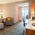 Courtyard by Marriott Pueblo Downtown guest suite with sofa, chair, desk and adjoining sitting area