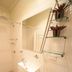 Westside Studio Apartments in Armidale bathroom with shower, vanity sink, mirror and wall shelves