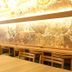 Koko Hotel Osaka Namba Ebisucho dining area with wooden tables, chairs, and ornate illuminated wall art