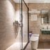 24k International Hotel People's Square bathroom in Shanghai with glass shower, wall-mounted sink and toilet