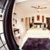 Radio Tulum guest room with bed, desk, ceiling fan and purple rug in Tulum