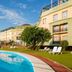 Poolside view of Ilunion Alcora Sevilla in San Juan de Aznalfarache with loungers and hotel exterior