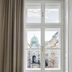 Rosewood Vienna in Vienna: window view of a domed landmark over a street, beside a navy chair and table