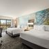 Courtyard by Marriott Roseville guest room with two beds, desk, mural wall and balcony view