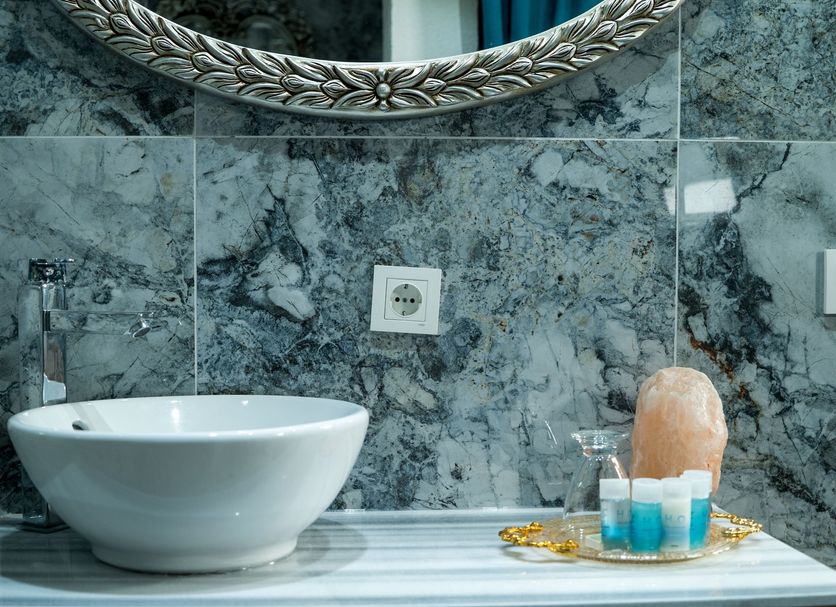 Taksim Yazici Residence Istanbul bathroom with vessel sink, marble wall, mirror and toiletries