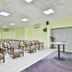 OYO 2494 Hotel Shree Plaza in Bharūch conference room with rows of chairs and presentation table