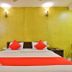 OYO 2494 Hotel Shree Plaza in Bharuch bedroom with red bed runner and lime green wall