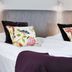 Bofors Hotel in Karlskoga guest room with twin beds, floral pillows and folded towels