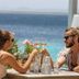 Couple toasting at Grand Windsock Bonaire in Kralendijk with ocean view dining terrace