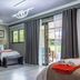 Sunrock Guesthouse in Kempton Park guest room with twin beds, balcony door and modern ceiling light