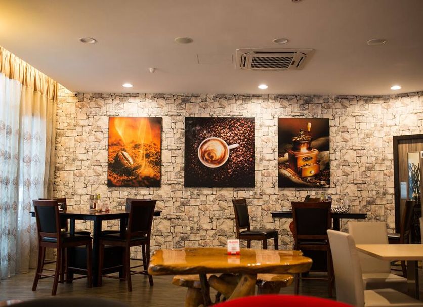 Orkid Inn Mahkota Cheras Kuala Lumpur dining area with stone wall art and tables