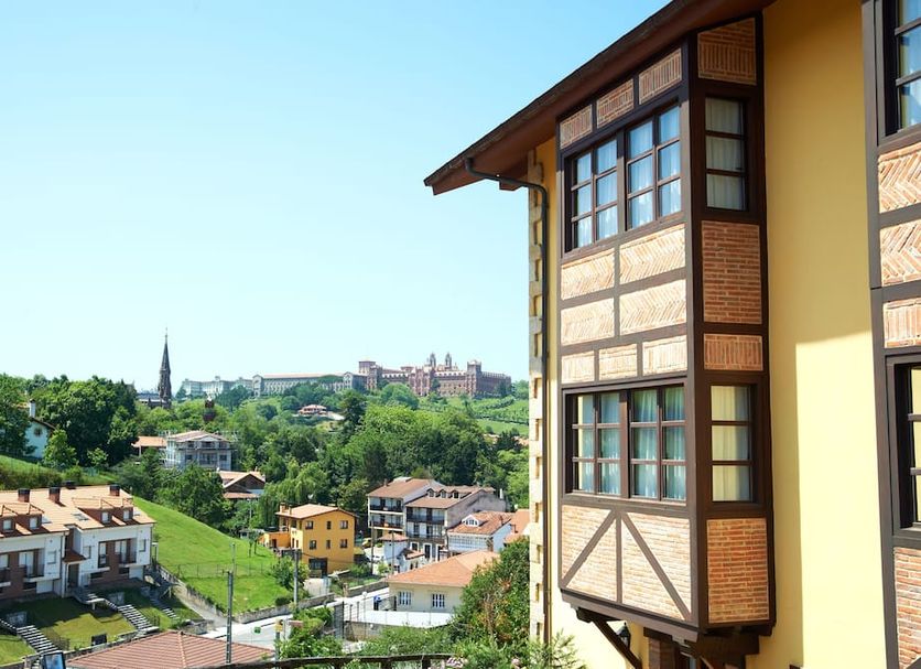 La Solana Montañesa in Comillas with hillside town views beside a timber-framed hotel exterior