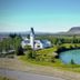 Hotel Selfoss in Selfoss with a riverside view, green grounds, and mountain backdrop