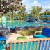 Colony Hotel & Cabana Club in Delray Beach with tropical pool, blue loungers and palm trees