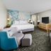 Courtyard by Marriott Dallas Lewisville guest room with two seating chairs and TV
