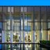 Al Zorah Beach Resort in Ajman with modern glass facade and reflecting pool at dusk