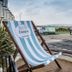 Delmont Hotel in Scarborough with striped deck chair overlooking the seaside promenade and bay