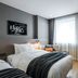 Hotel28 Myeongdong Seoul guest room with two beds, desk, chair, and large window with curtains