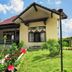 Hotel Sibayak International in Berastagi with tiled-roof bungalow and landscaped garden